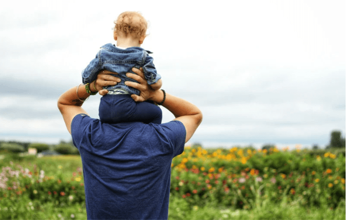 father with son on his shoulders